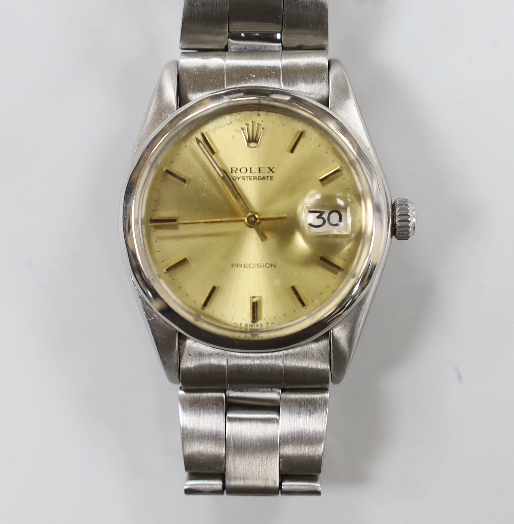 A gentleman's 1970's stainless steel Rolex Oysterdate precision wrist watch, with yellow dial, on a stainless steel Rolex bracelet, model number 6694 serial no. 3737889, no box or papers, case diameter 35mm.